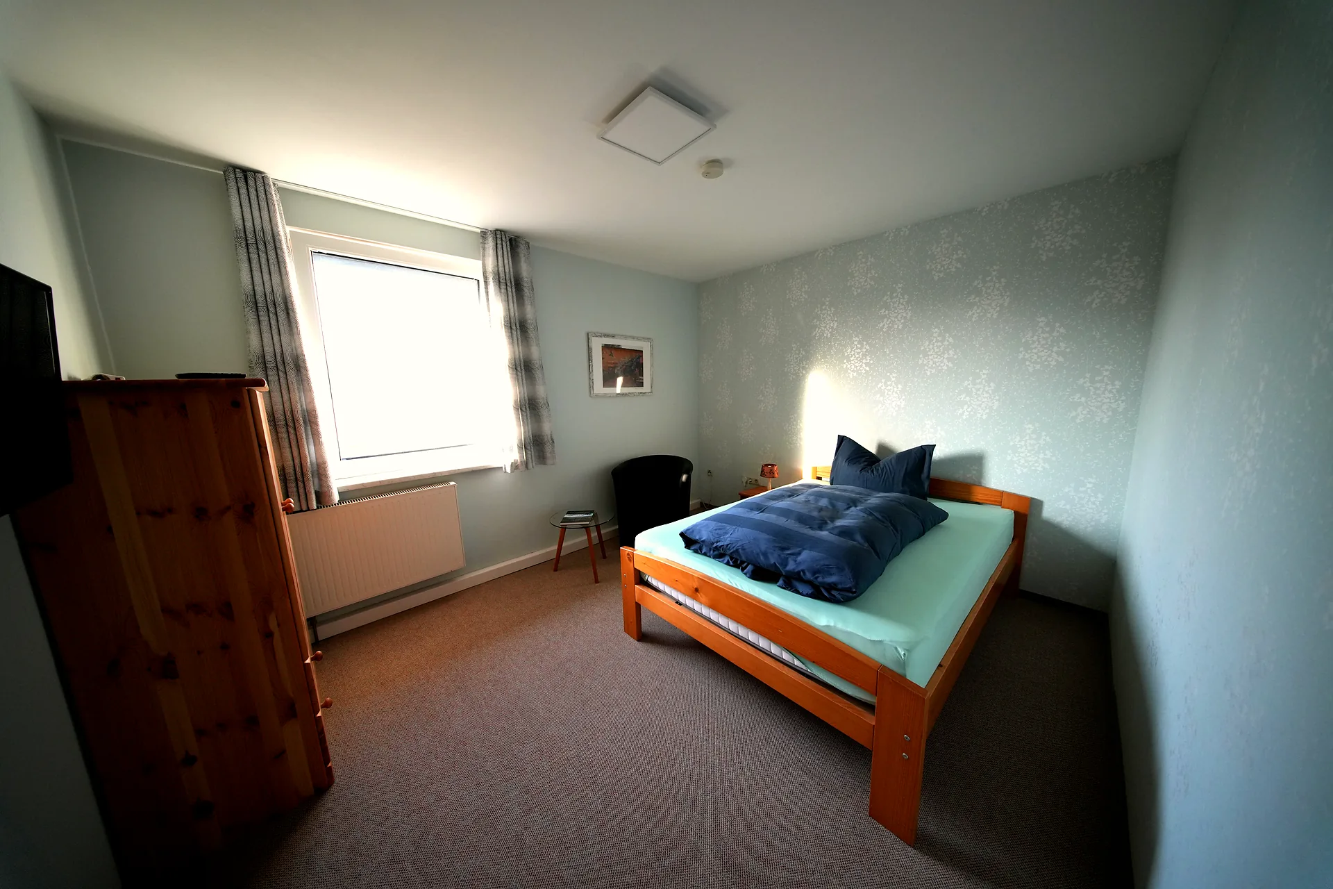 Single room with single bed, wardrobe and window