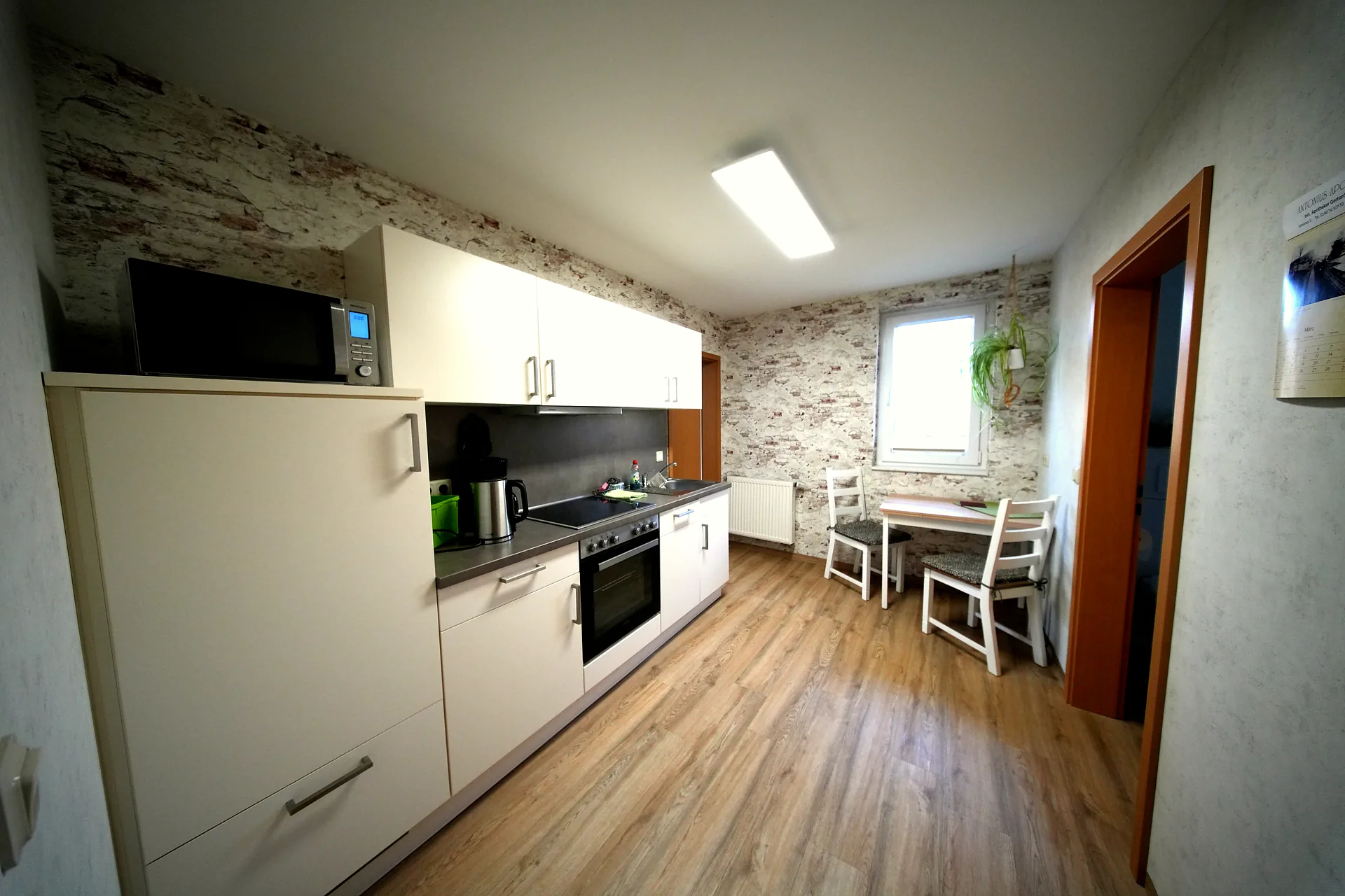 Fully equipped kitchen with stove, microwave and dining table