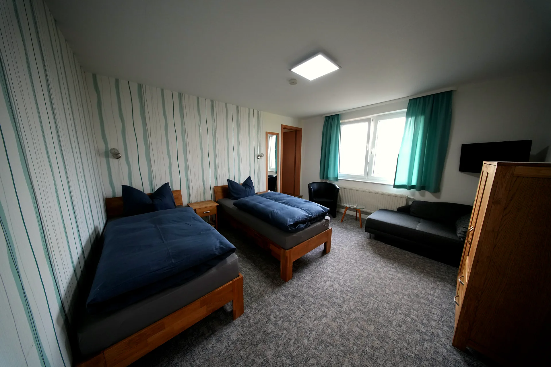 Rose Garden – Both single beds with window and turquoise curtains