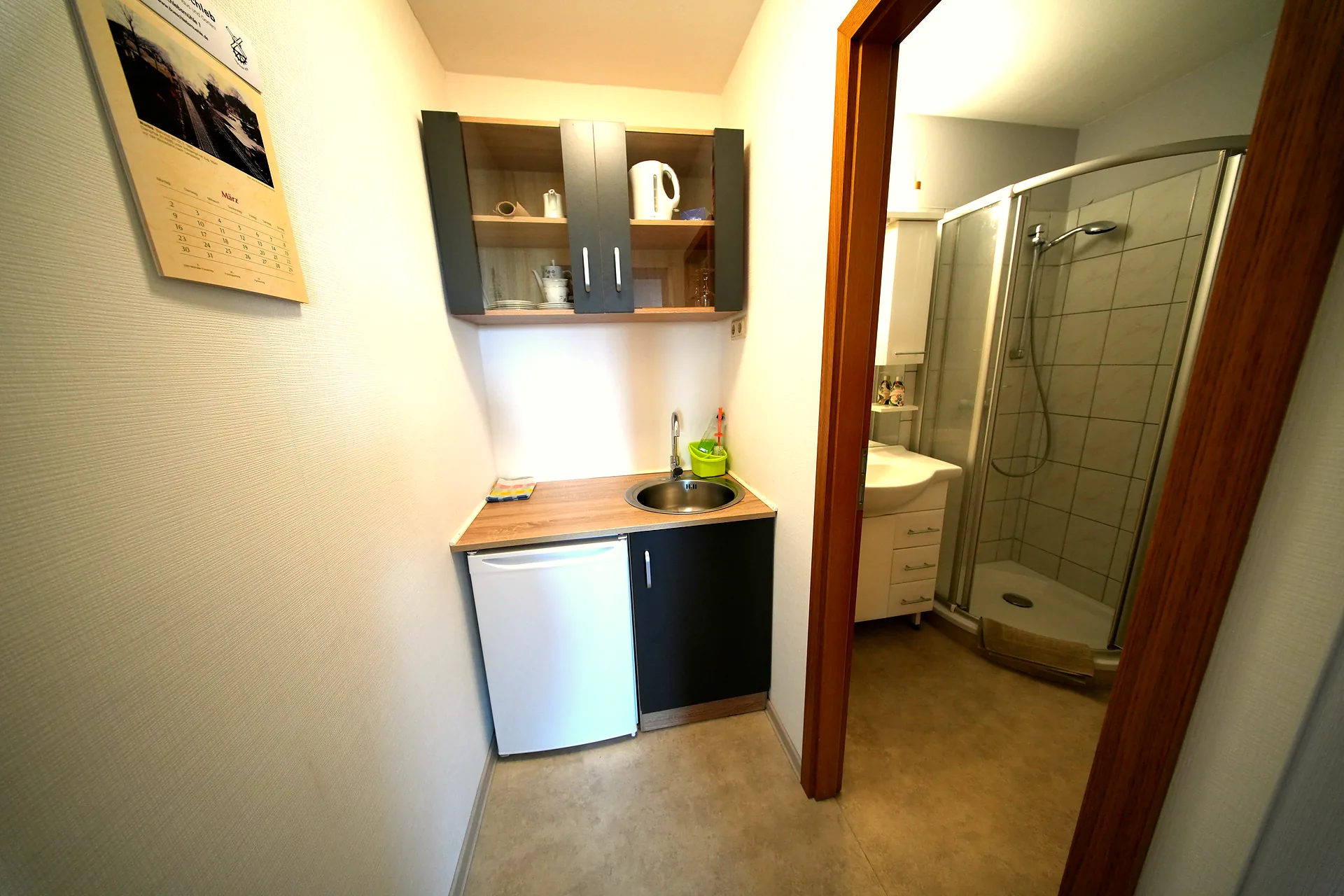 Kitchenette with kettle, refrigerator and sink